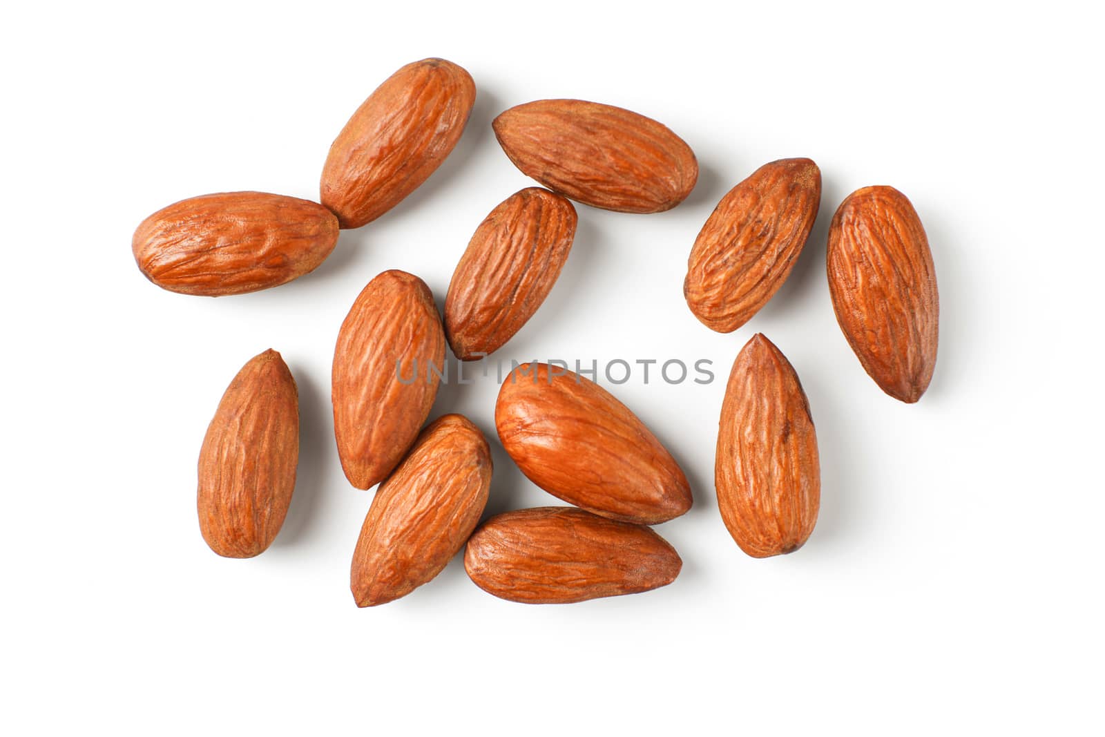 Top view on pile of almond nuts isolated on white background. by Ivanko