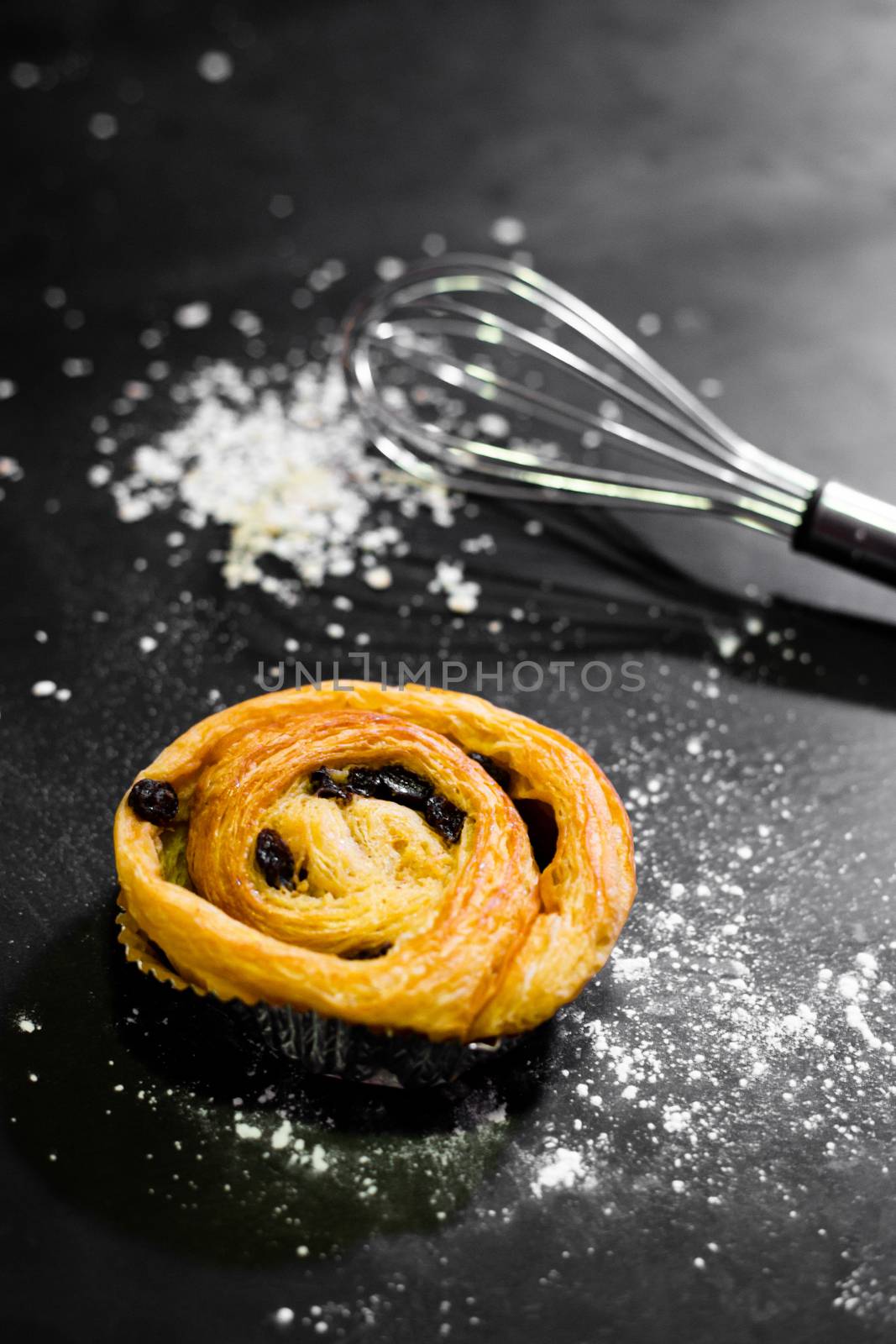 Raisin Bread on a black background, Cinnamon Roll, Butter and Raisin, Homemade Fresh Bakery Idea, Image from the top view