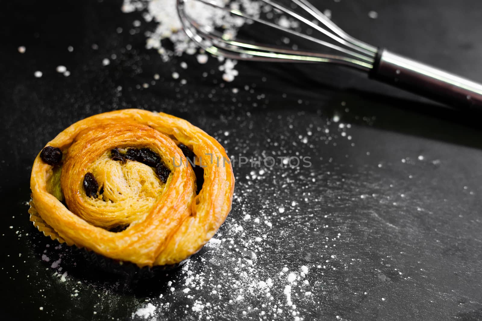 Raisin Bread on a black background, Cinnamon Roll, Butter and Raisin, Homemade Fresh Bakery Idea, Image from the top view