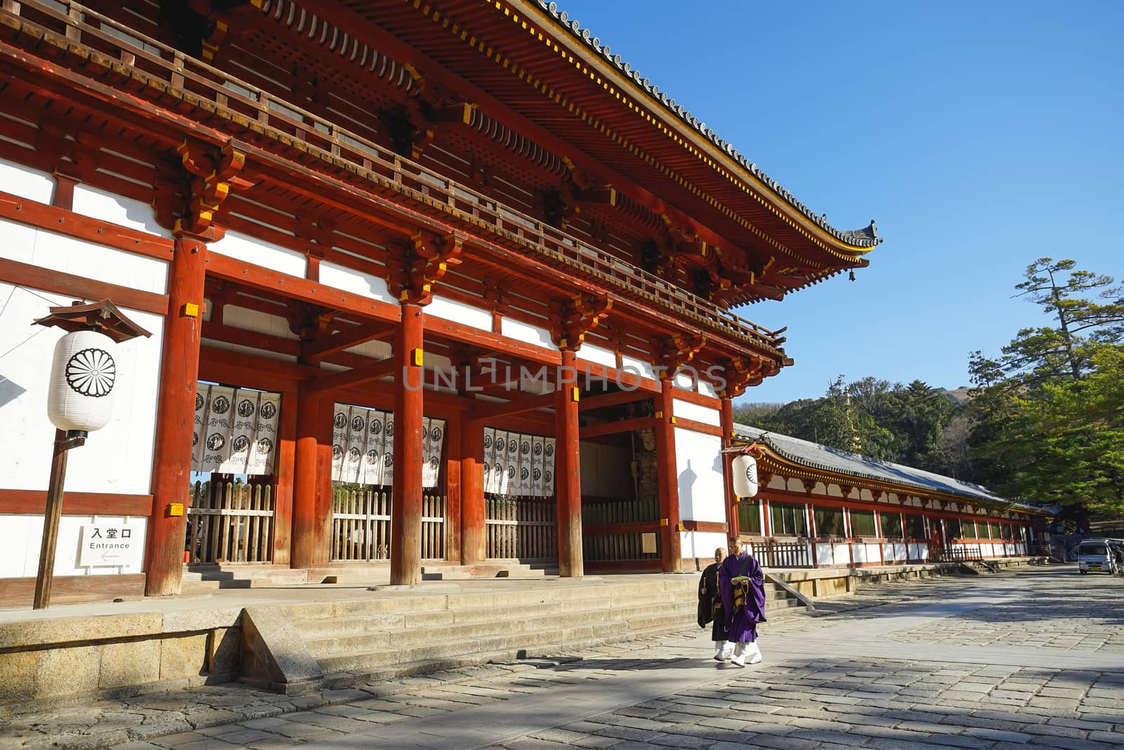 Nara, Japan - December 16, 2019 : Japanese monks are walking pass the second Wooden gate Of Todaiji Temple, this is the most famous travel destinations of Nara city in Kansai area of Japan.
