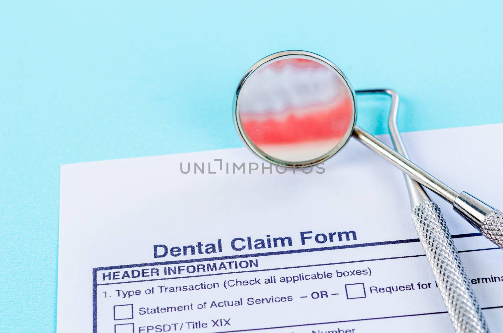 Dental claim Form with model tooth and dental instruments. Dental health and teeth care concept.