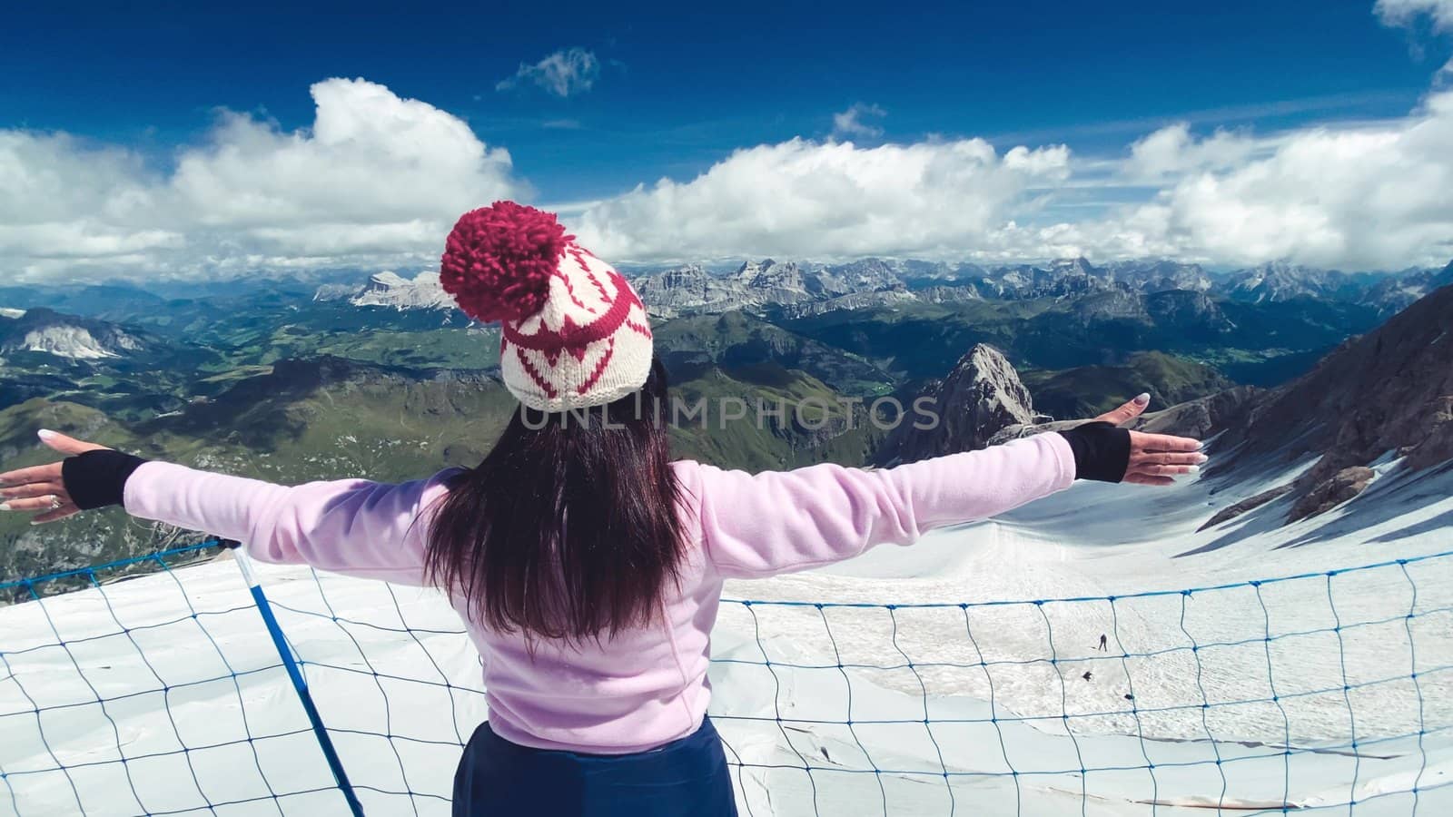 Woman embracing wonderful mountain landscape with glacier