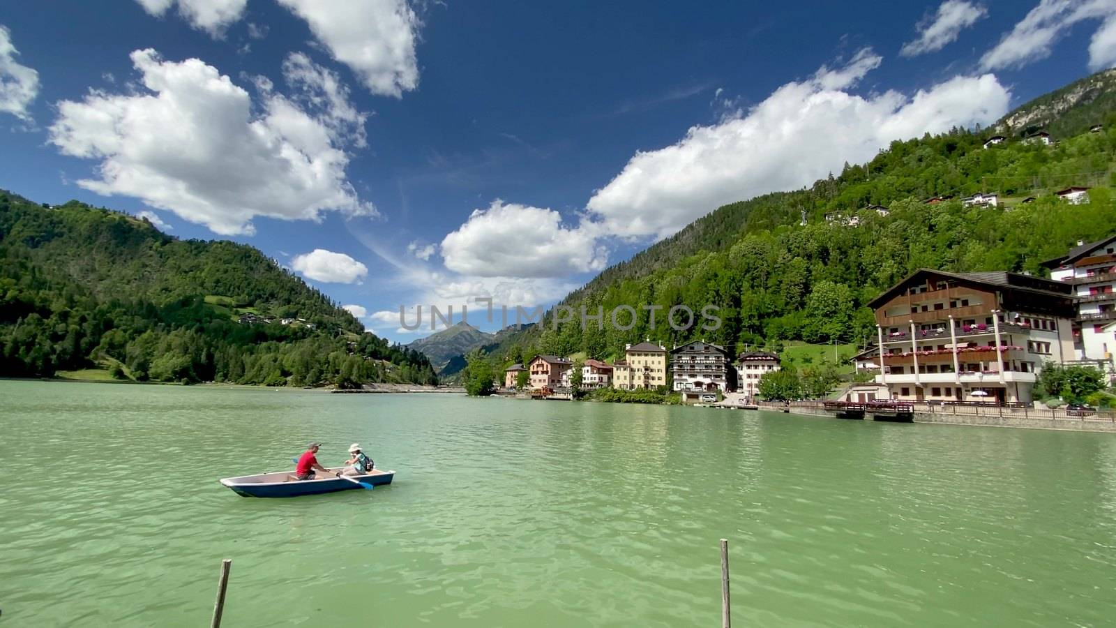 ALLEGHE, ITALY - AUGUST 2020: Boat on the beautiful lake in summ by jovannig