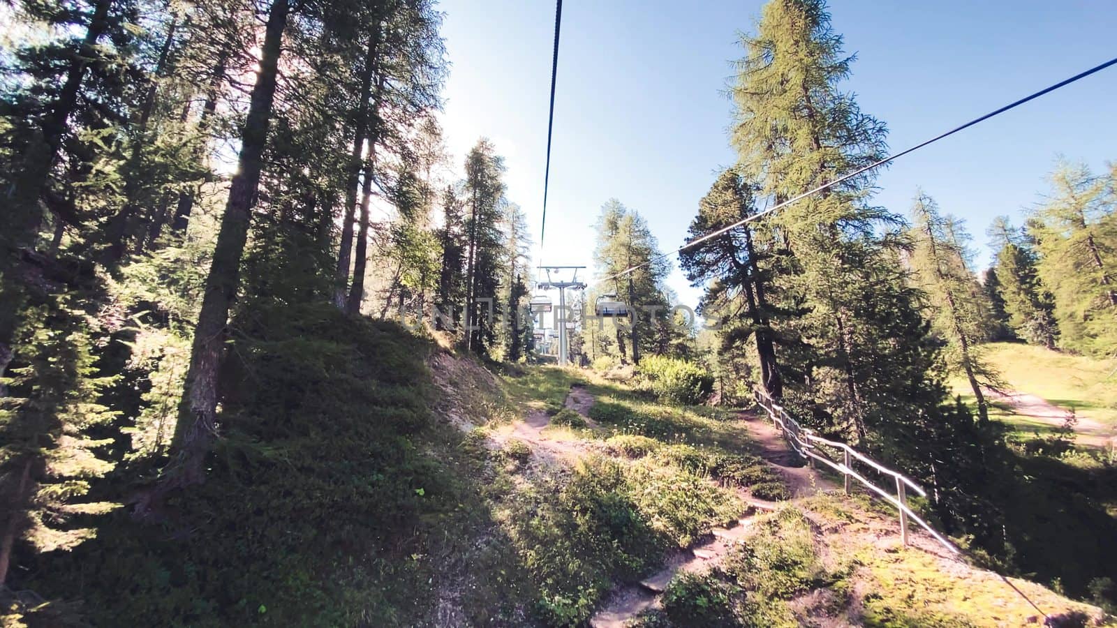 Chairlift moving to a mountain peak.