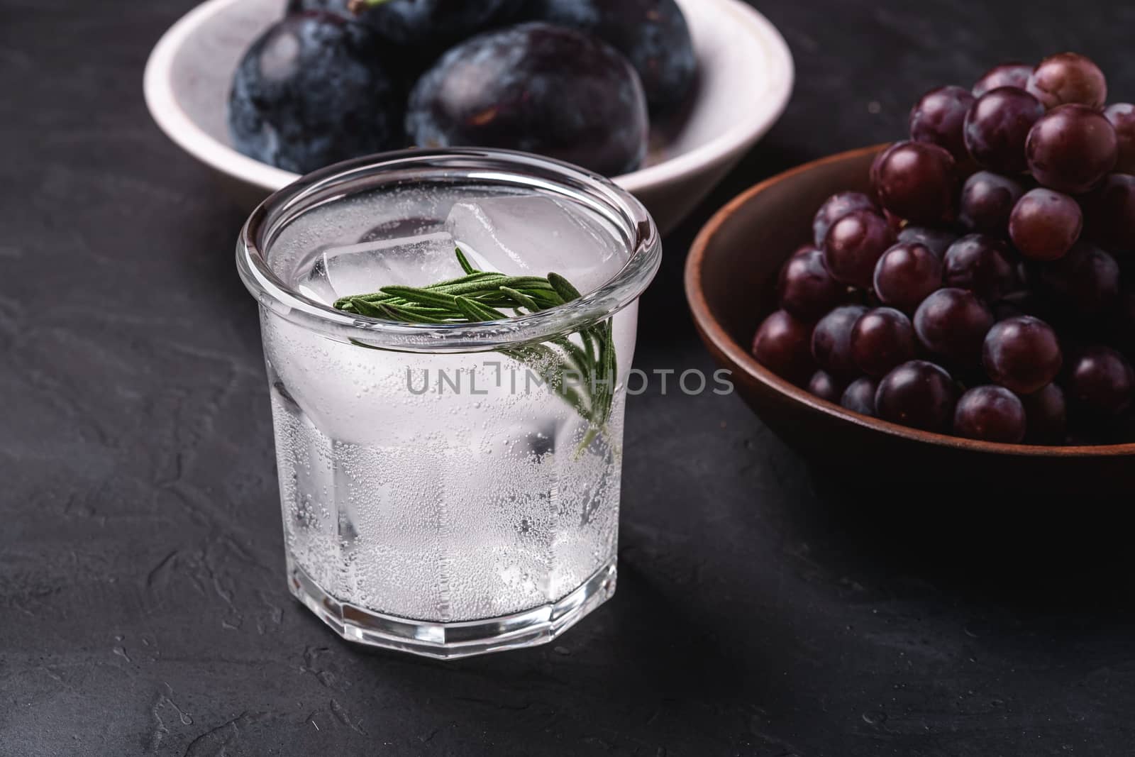 Fresh ice cold carbonated water in glass with rosemary leaf by Frostroomhead