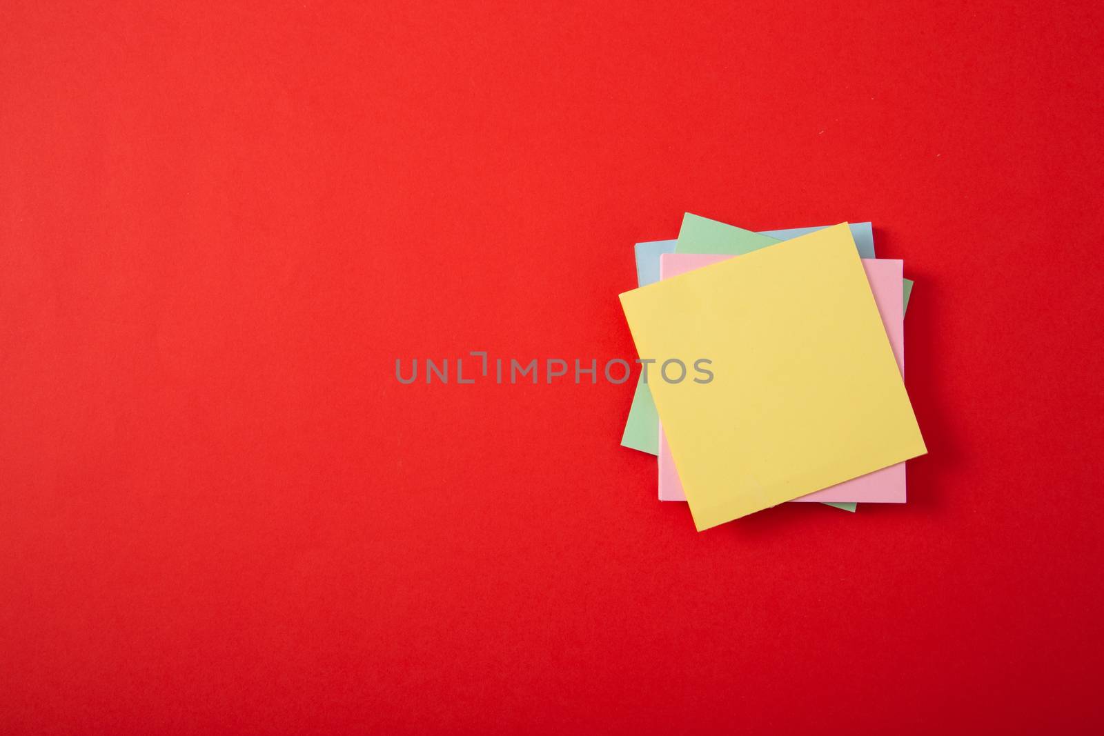 color sticky note pad on red background