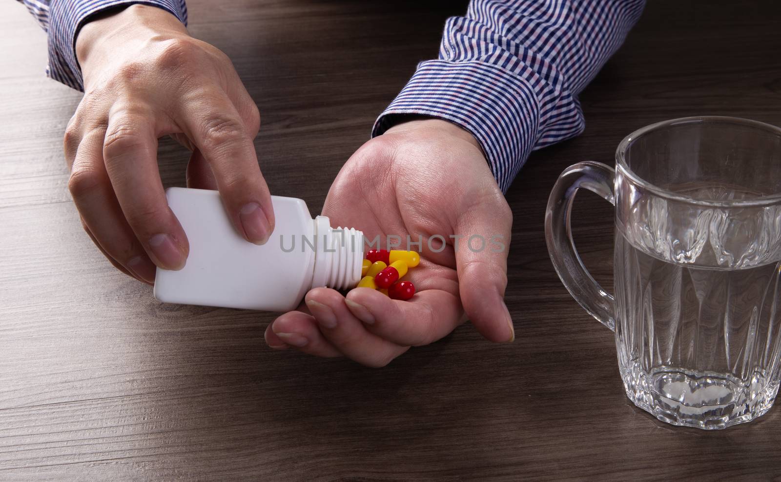 close up of senior man hand taking pills
