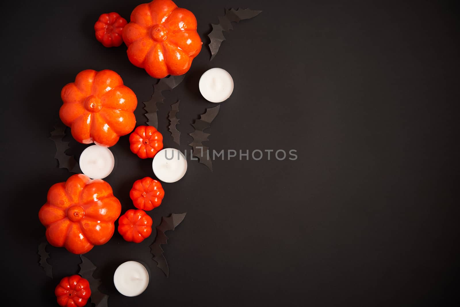 Halloween background, orange decorative plastic pumpkin black paper bat black cardboard Thanksgiving greeting card pattern