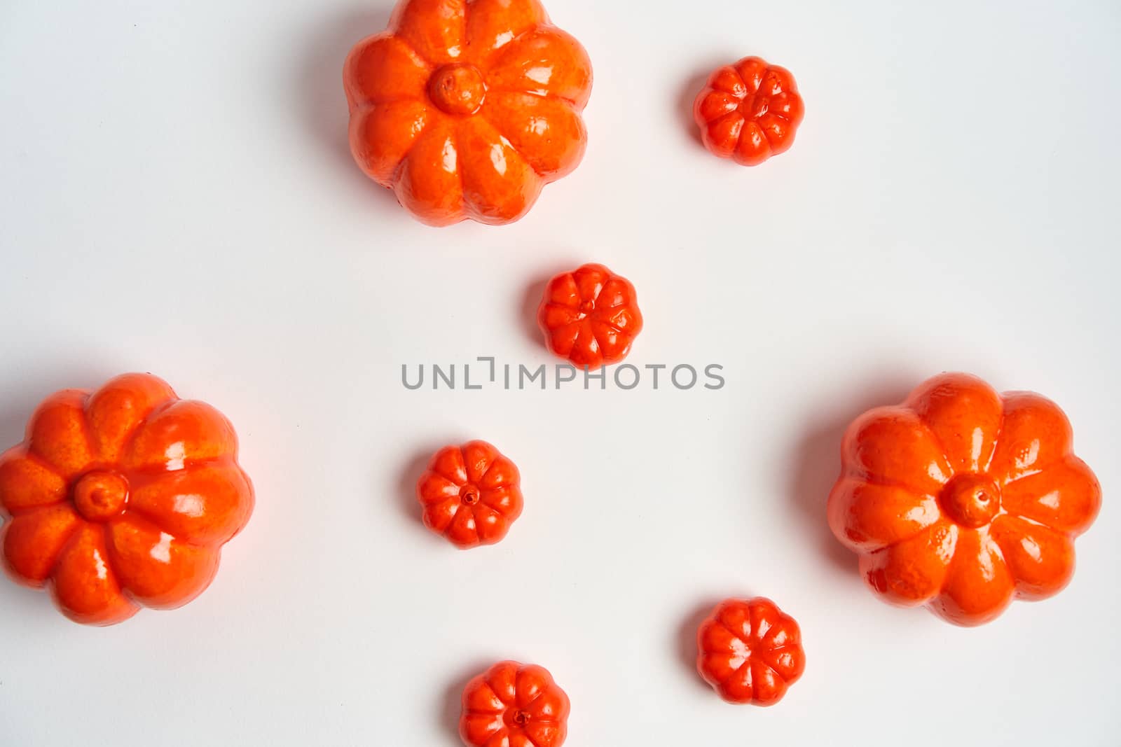 Halloween background, orange decorative plastic pumpkin white cardboard Thanksgiving greeting card pattern