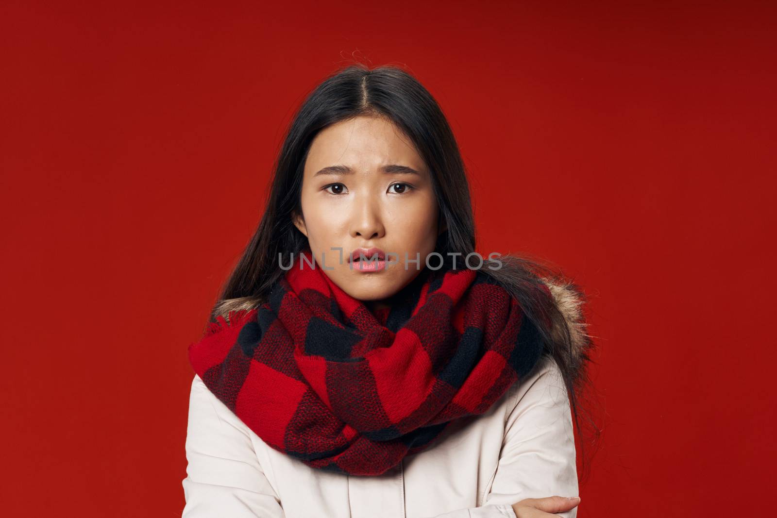 Woman in plaid scarf coolness lifestyle red background