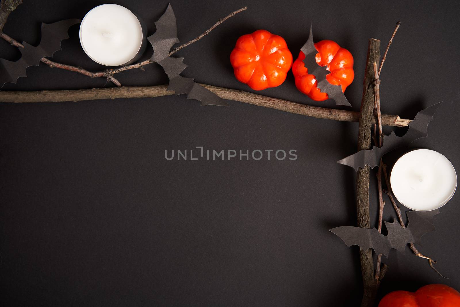 Halloween background, orange decorative plastic pumpkin black paper bat dry branch stick square frame black cardboard Thanksgiving greeting card pattern