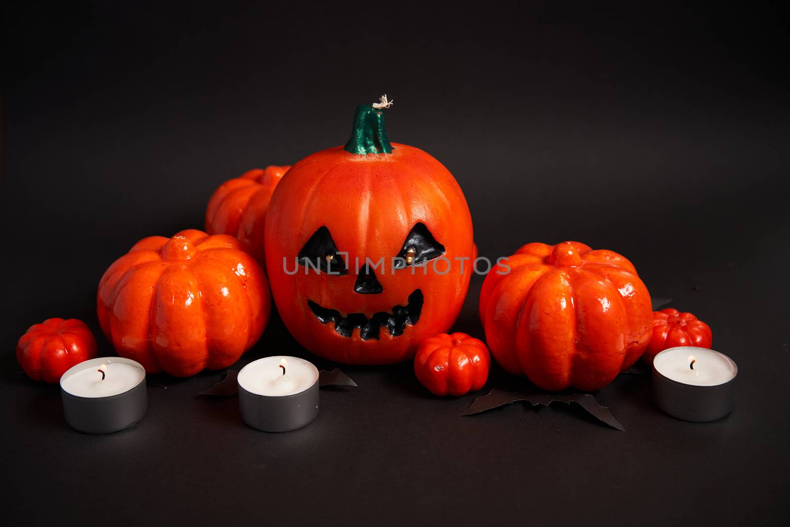 Halloween background, orange decorative plastic pumpkin black paper bat black cardboard Thanksgiving greeting card pattern