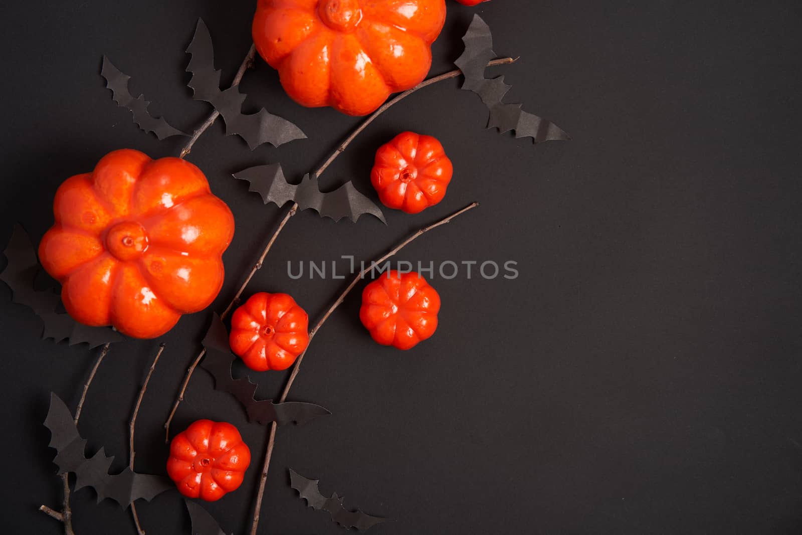 Halloween background, orange decorative plastic pumpkin black paper bat dry branch stick cardboard Thanksgiving greeting card pattern