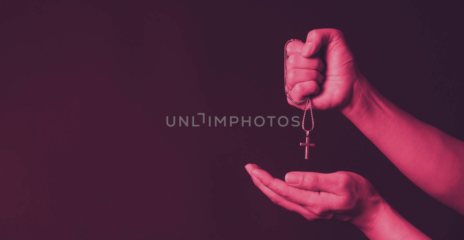 Crucifix pendant or cross sign made from silver and hold in man  by gnepphoto