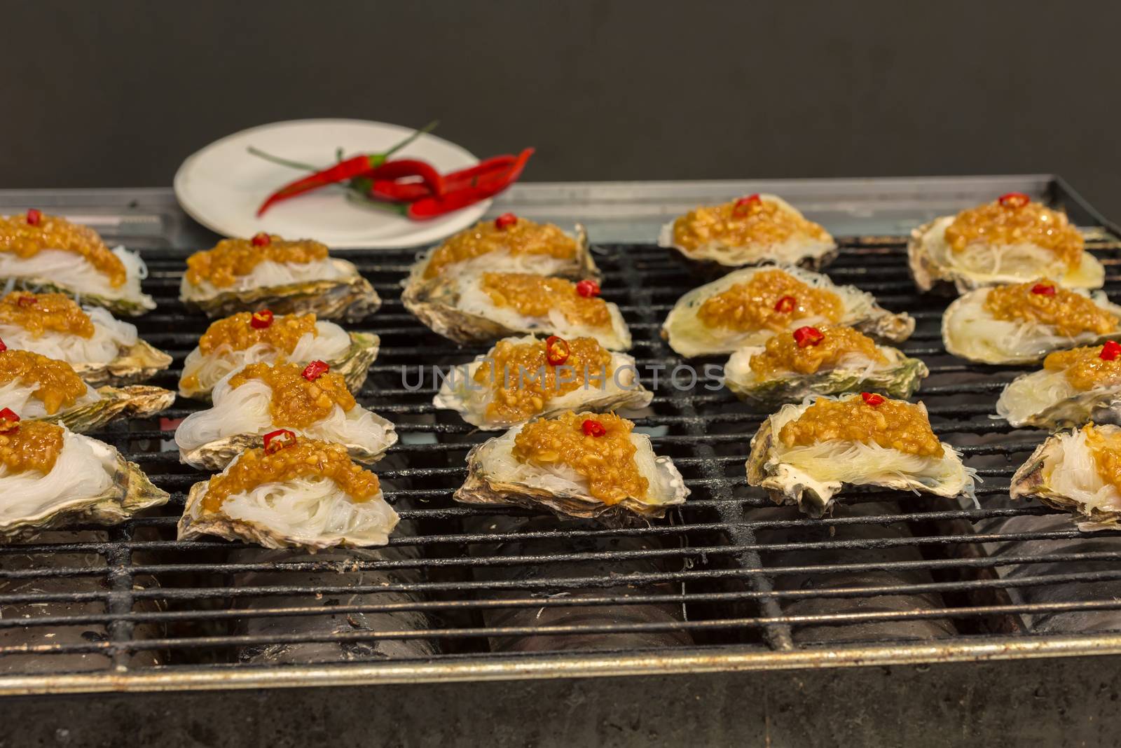 Street food asia. Grilled seafood. Oysters on the grill
