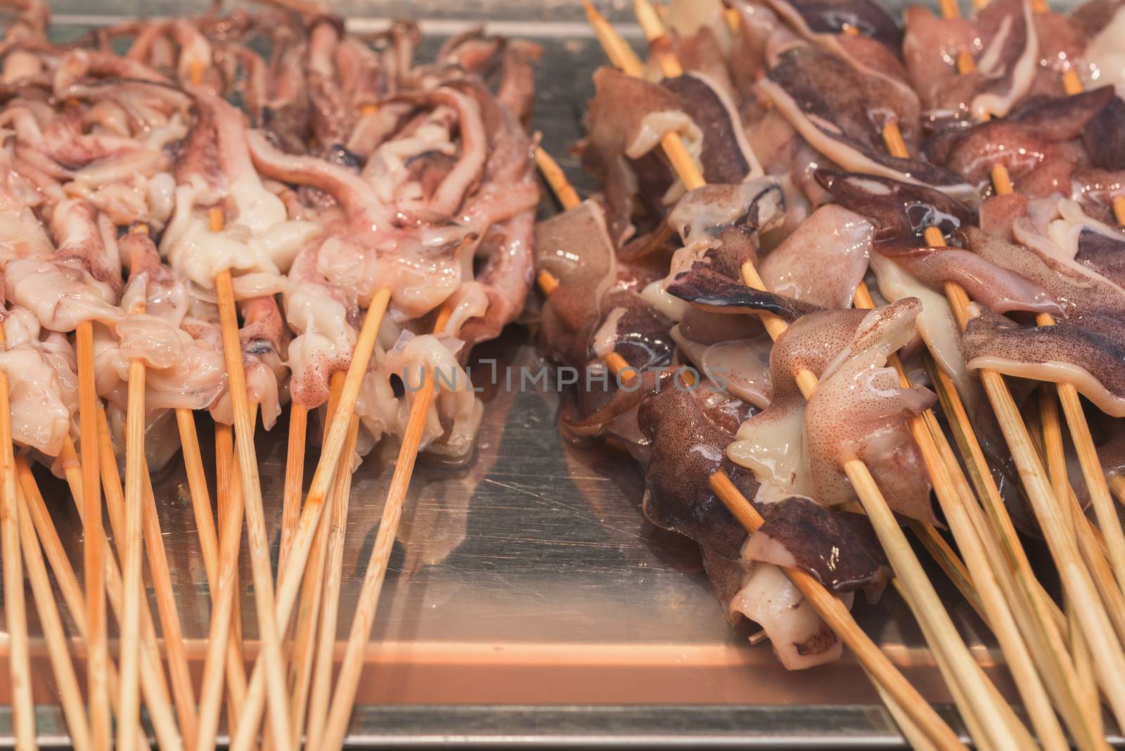 Street food asia. Squid on a stick.