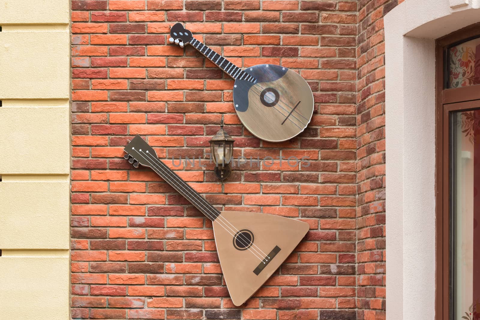 Musical instrument balalaika on the wall. Scenery on the wall of the building