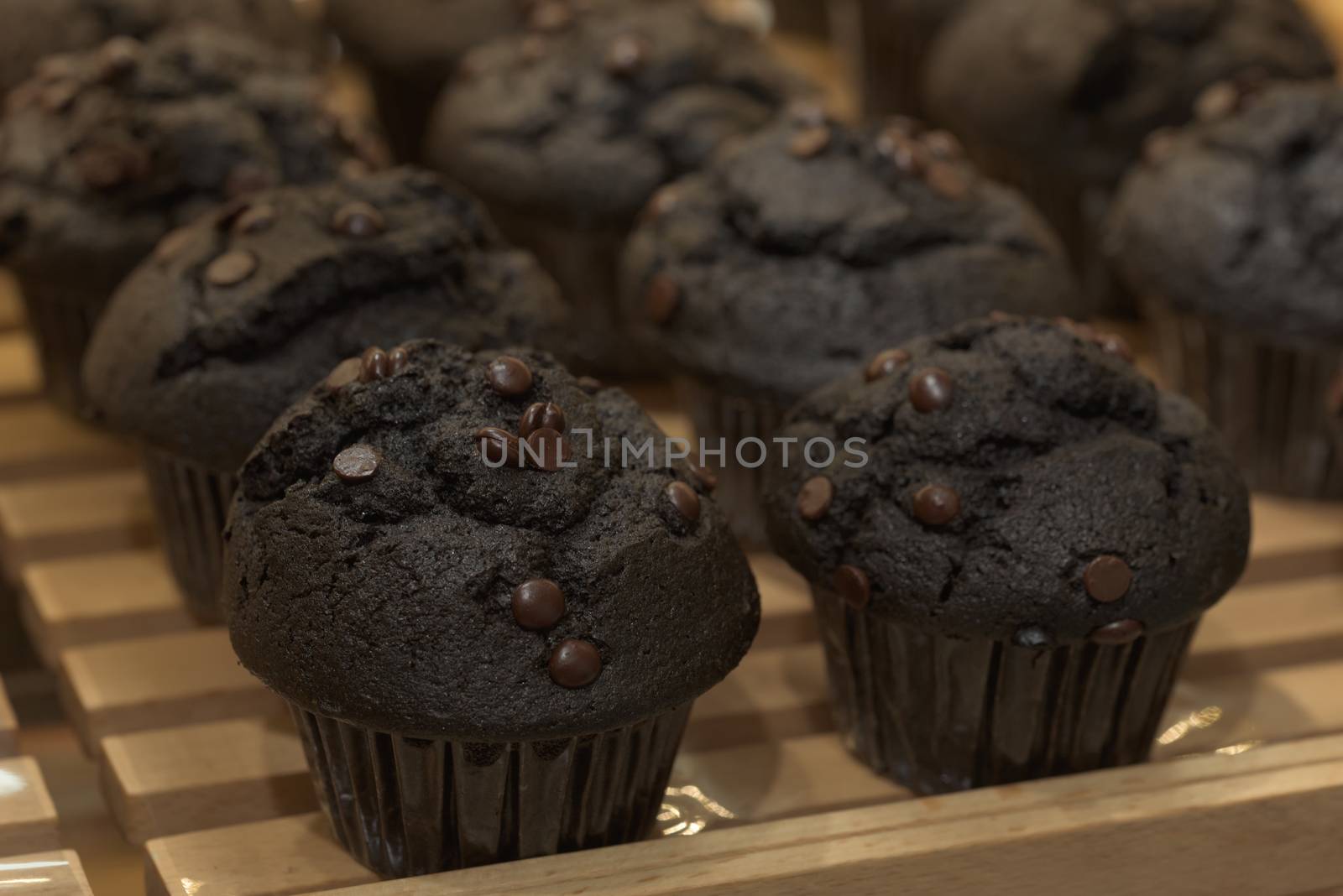 Chocolate cupcakes. Black cupcakes on a pallet