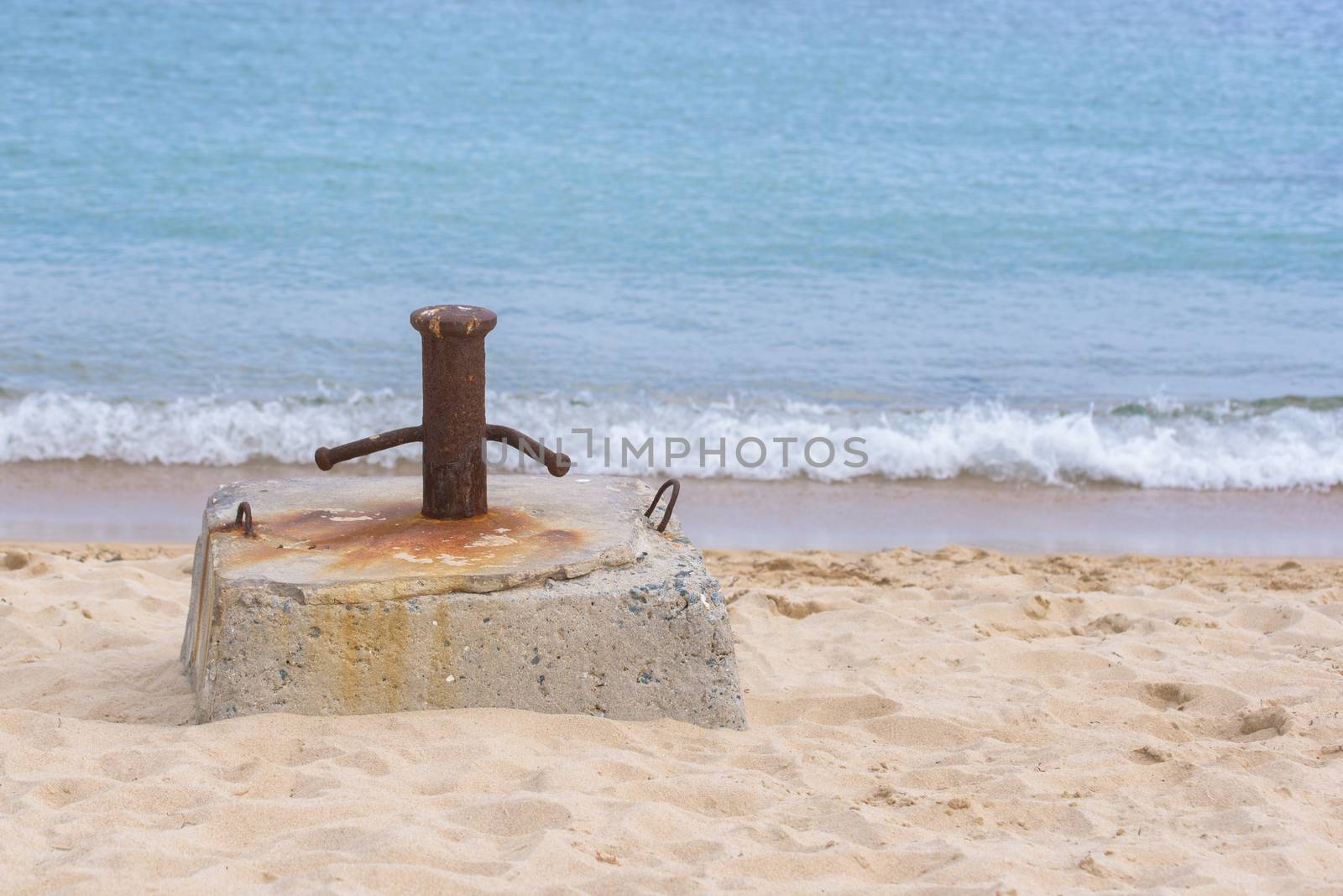bollard on the beach by Visual-Content