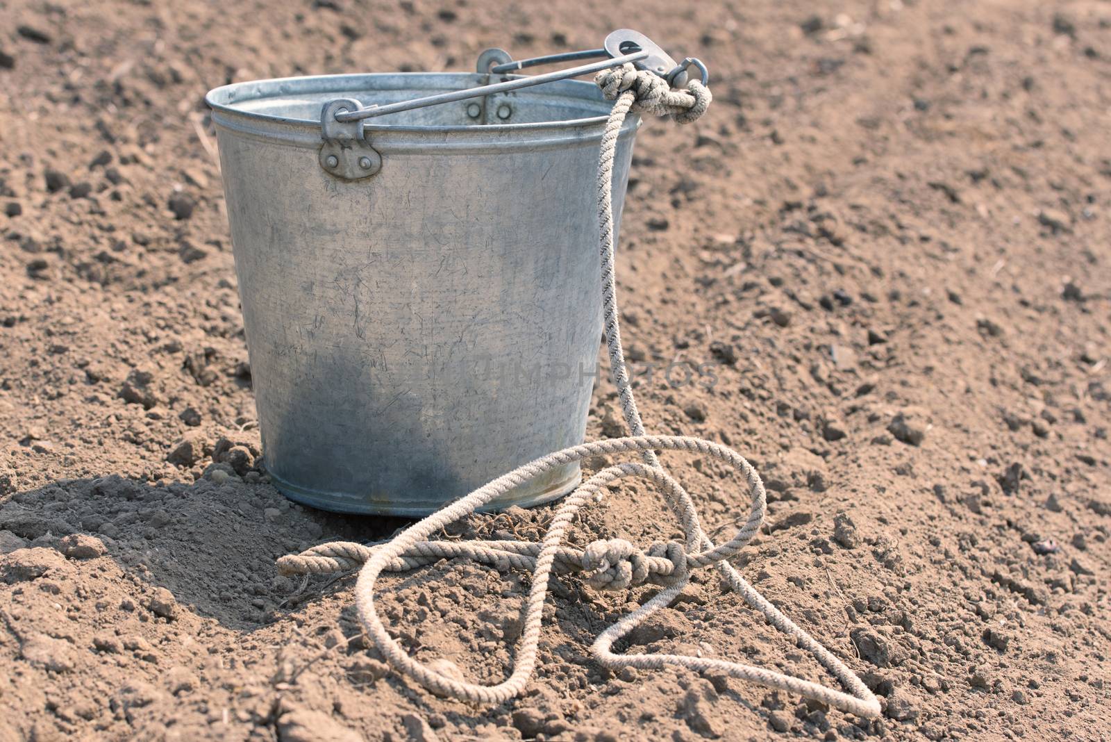 Bucket on the ground. Empty metal bucket