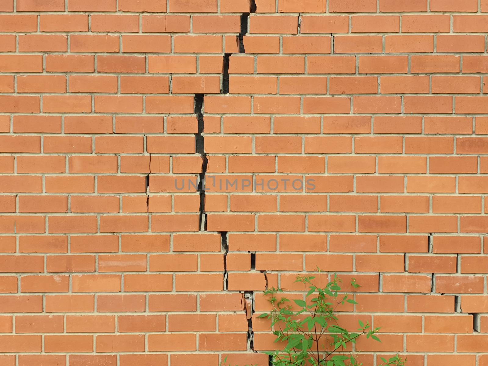 Cracked brick wall. Broken brick wall background