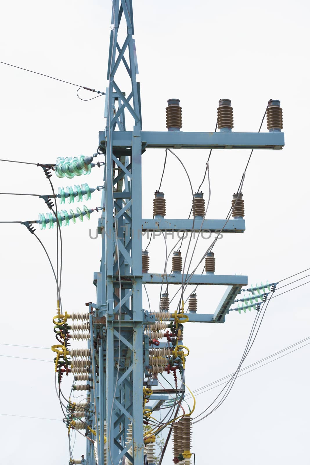 Electric pole on a white background. Garland of insulators on electric wires of high-voltage support