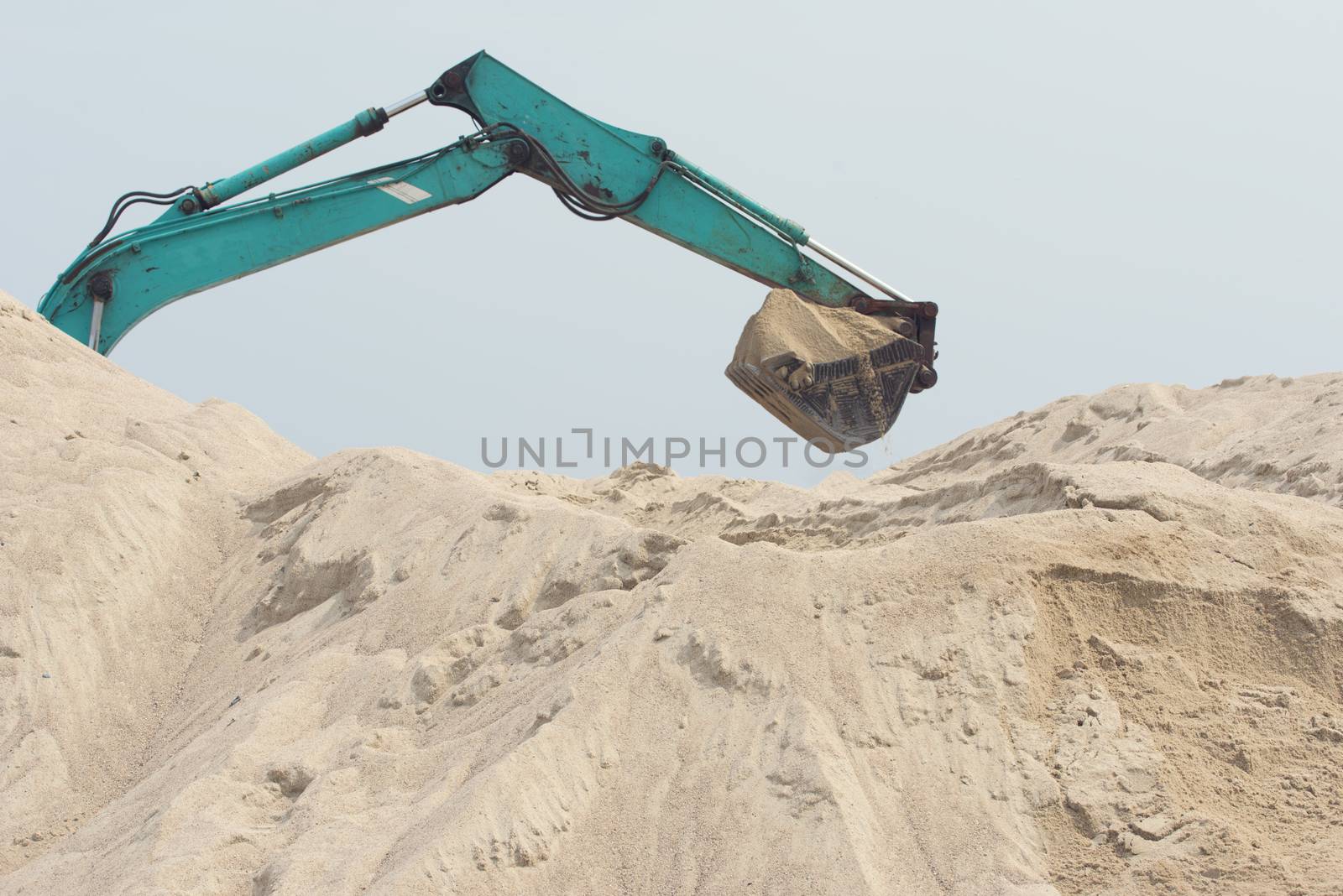 Excavator is digging sand. Construction excavator on the construction site in a quarry