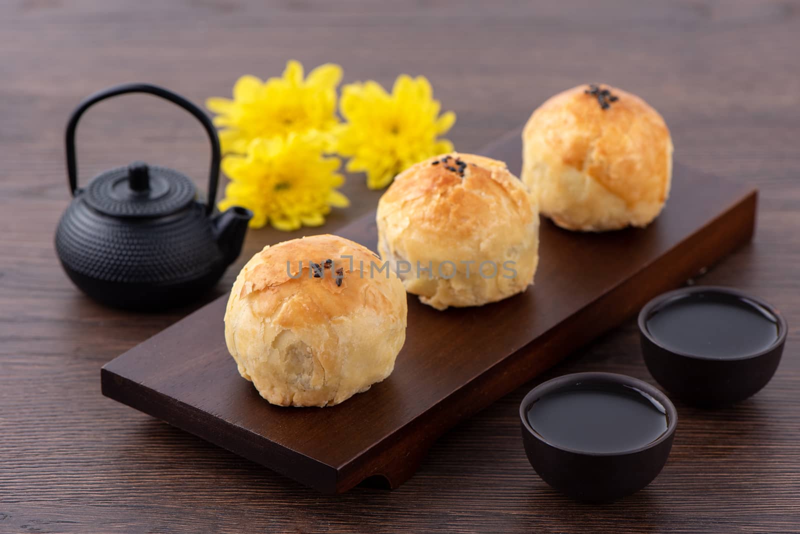 Moon cake yolk pastry, mooncake for Mid-Autumn Festival holiday, close up design concept on dark wooden table background