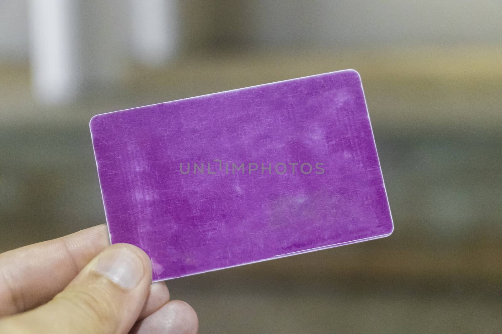 Purple card blank and empty in a human hand.