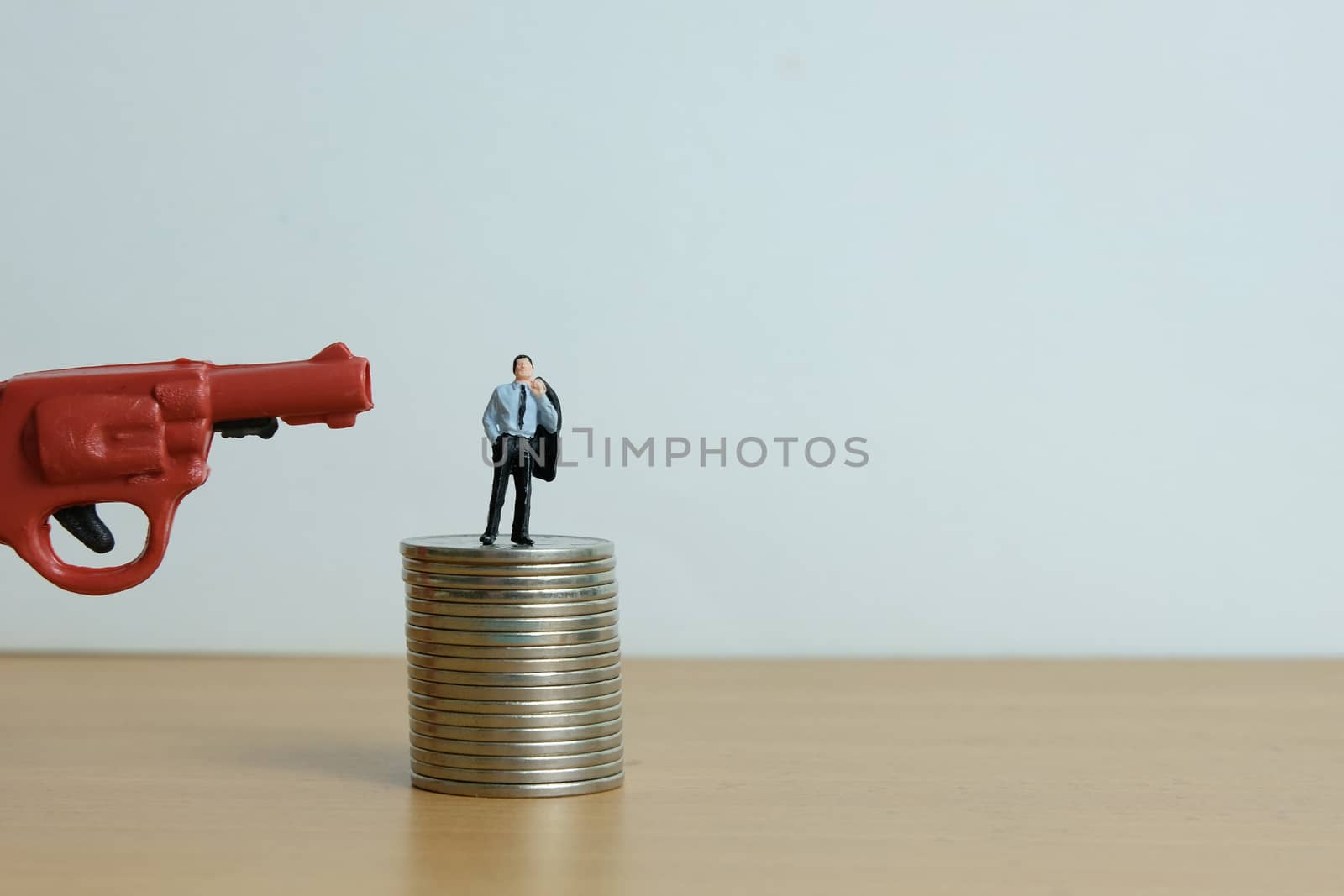 Miniature people concept - businessman thinking desperately for debt financial solution.