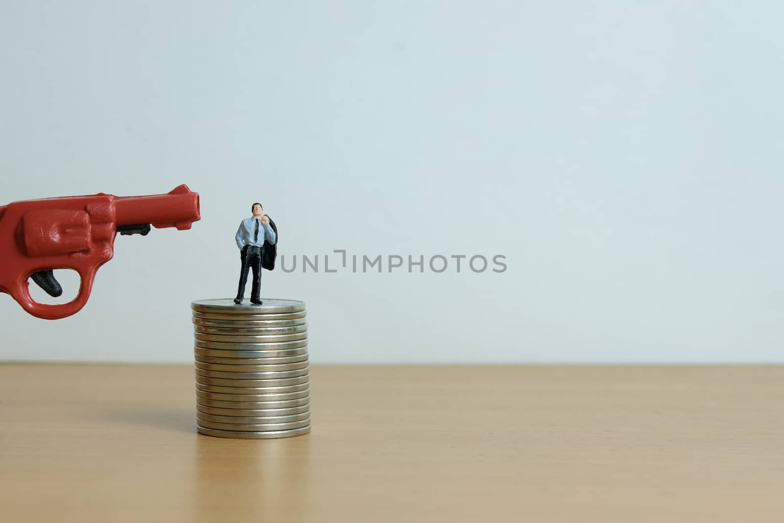 Miniature people concept - businessman thinking desperately for debt financial solution.