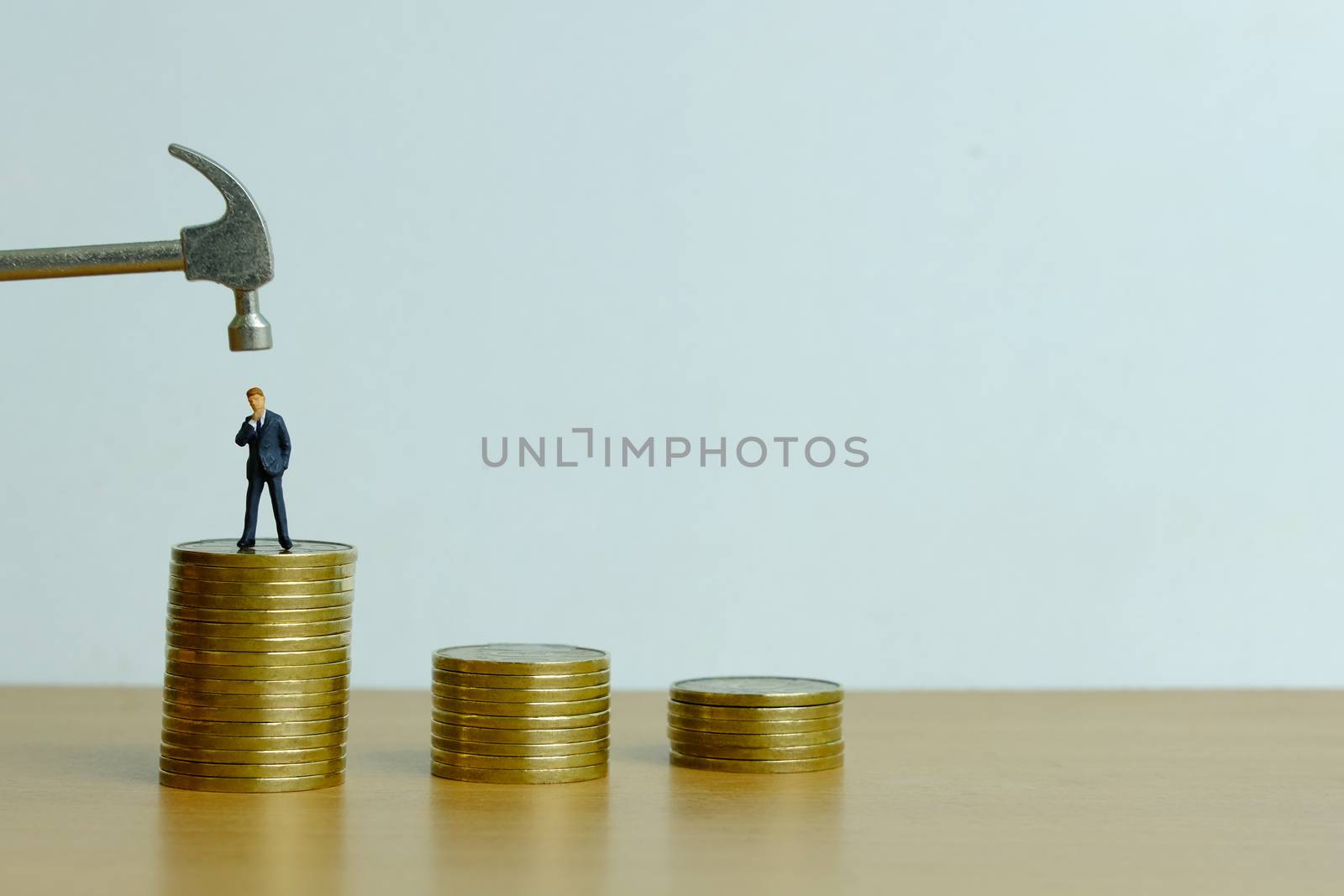 Miniature people concept - businessman stress thinking about financial crisis (toys photography )