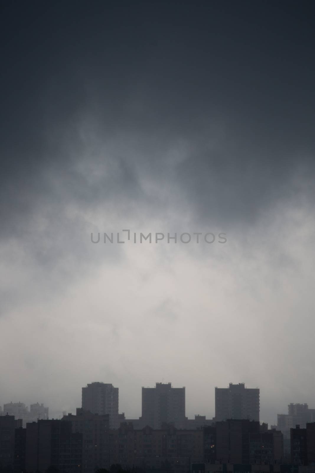 Gloomy dark city view on typical generic houses and dark cloudy sky