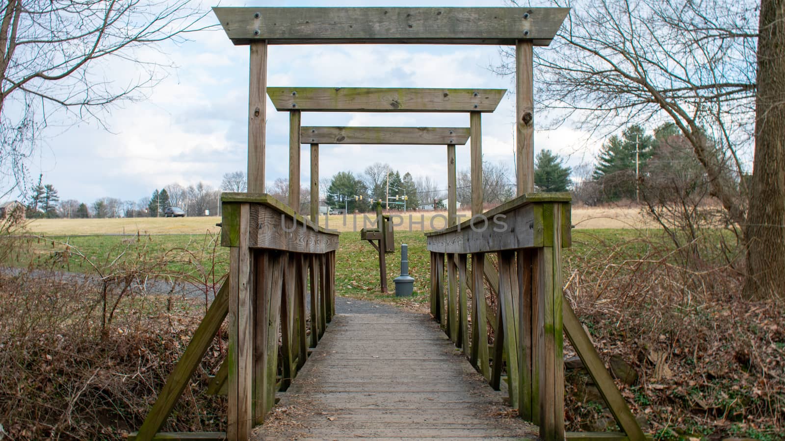 An Old Wooden Bridge Crossing a Small Creek in an Autumn Forest