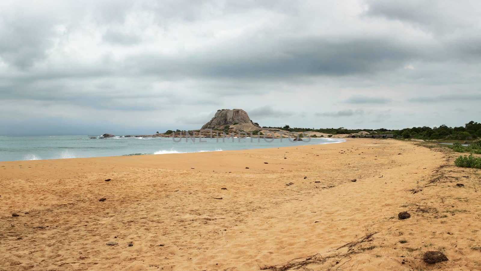 Beach with single hill (Patanangala rock) in distance on overcas by Ivanko