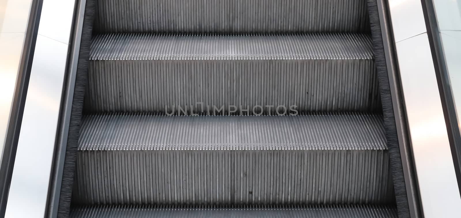 Close up of empty steps of an escalator in a perspective view. by MP_foto71