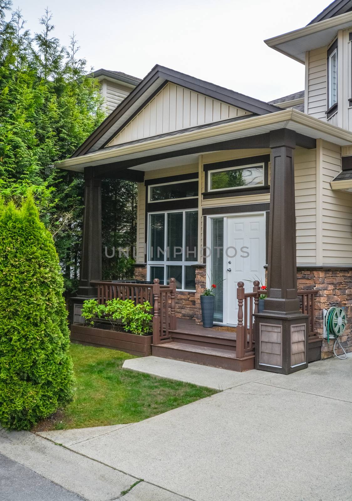 Main entrance of residential house with concrete pavement and doorsteps