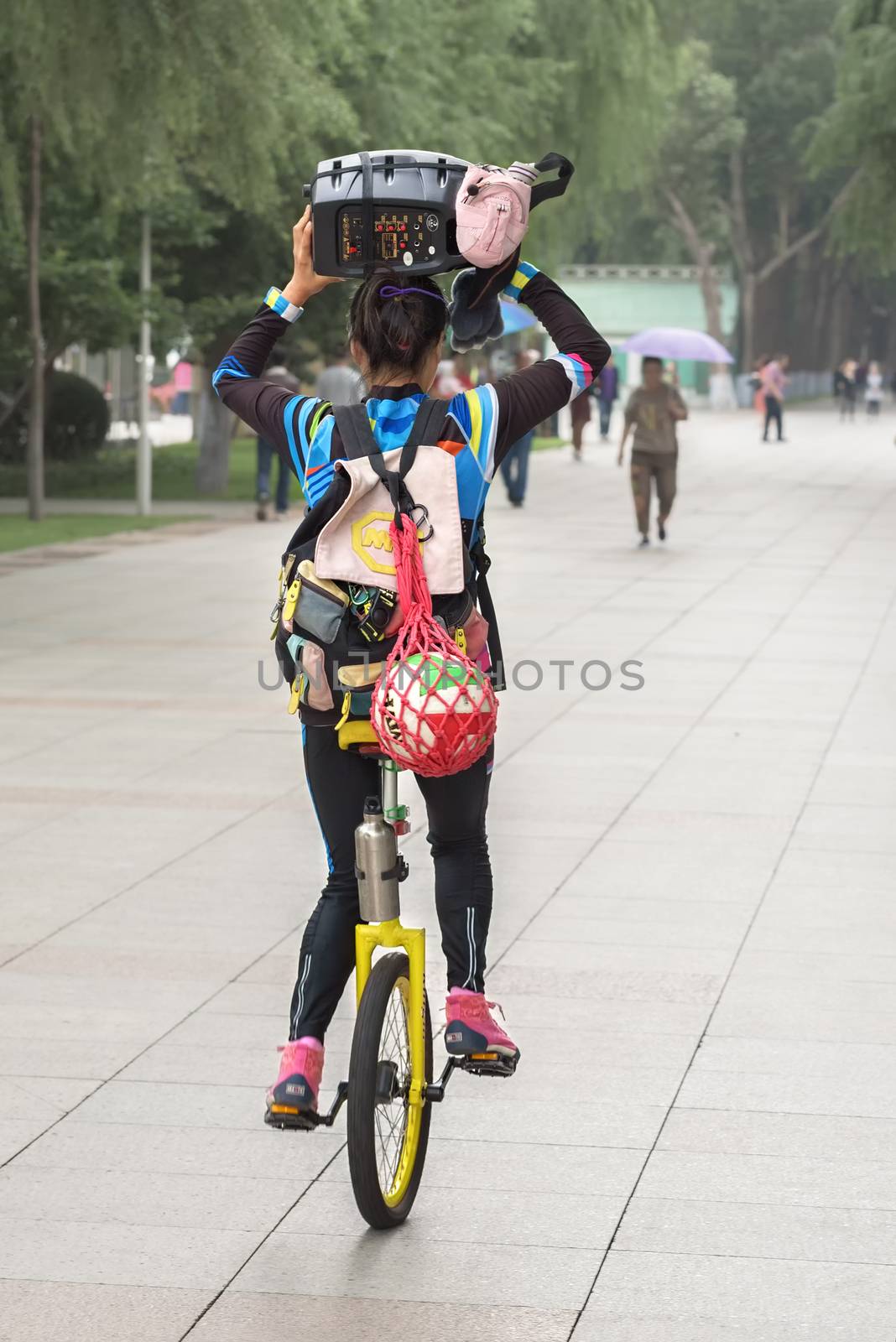 Harbin, Heilongjiang, China - September 2018: Girl driving unicycle outdoors. Girl on the unicycle