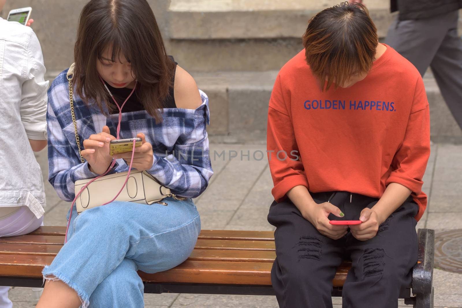 Harbin, Heilongjiang, China - September 2018: Woman using smart phone. Girls look at smartphones. Girl with phone
