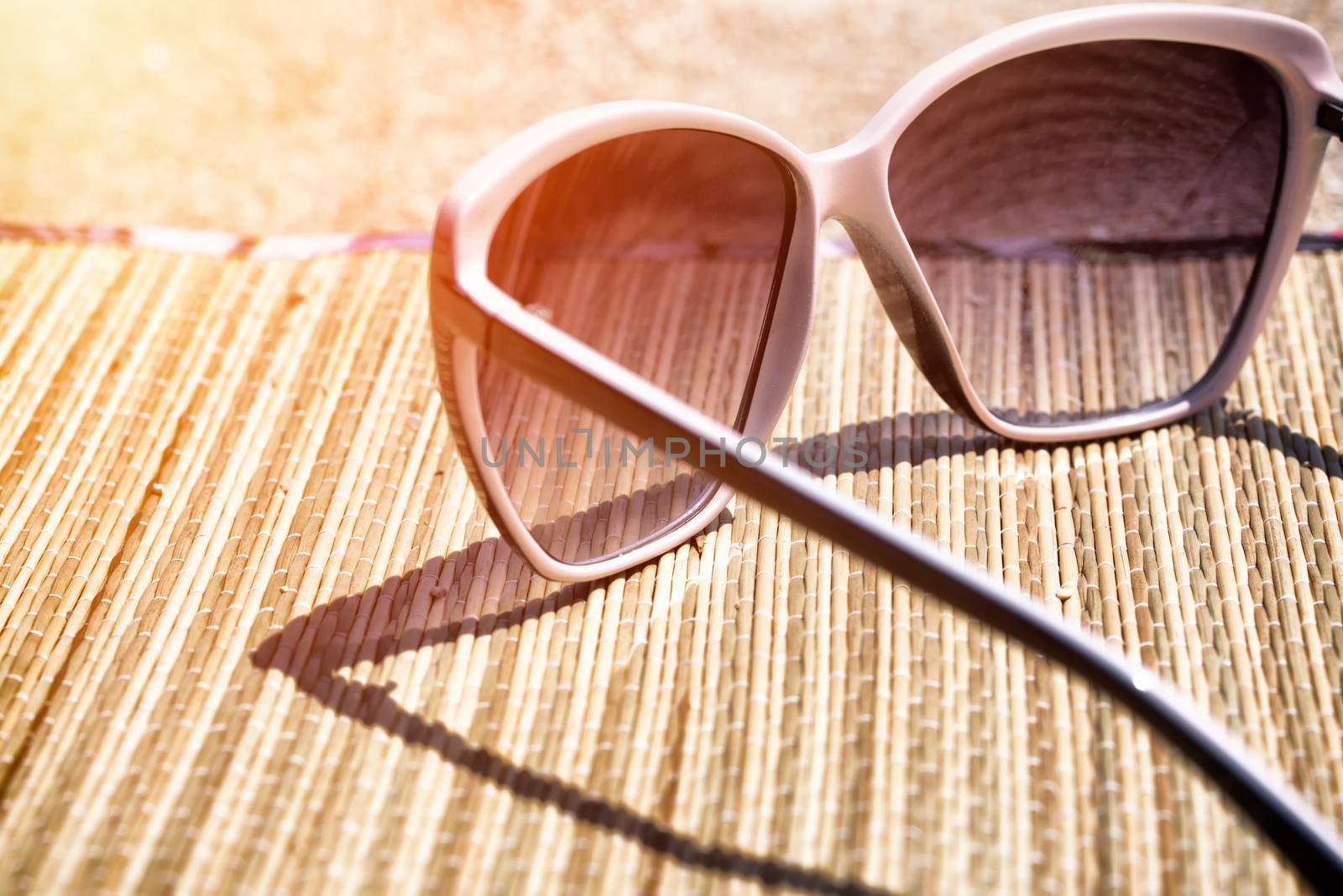 glasses on the beach sand by Visual-Content