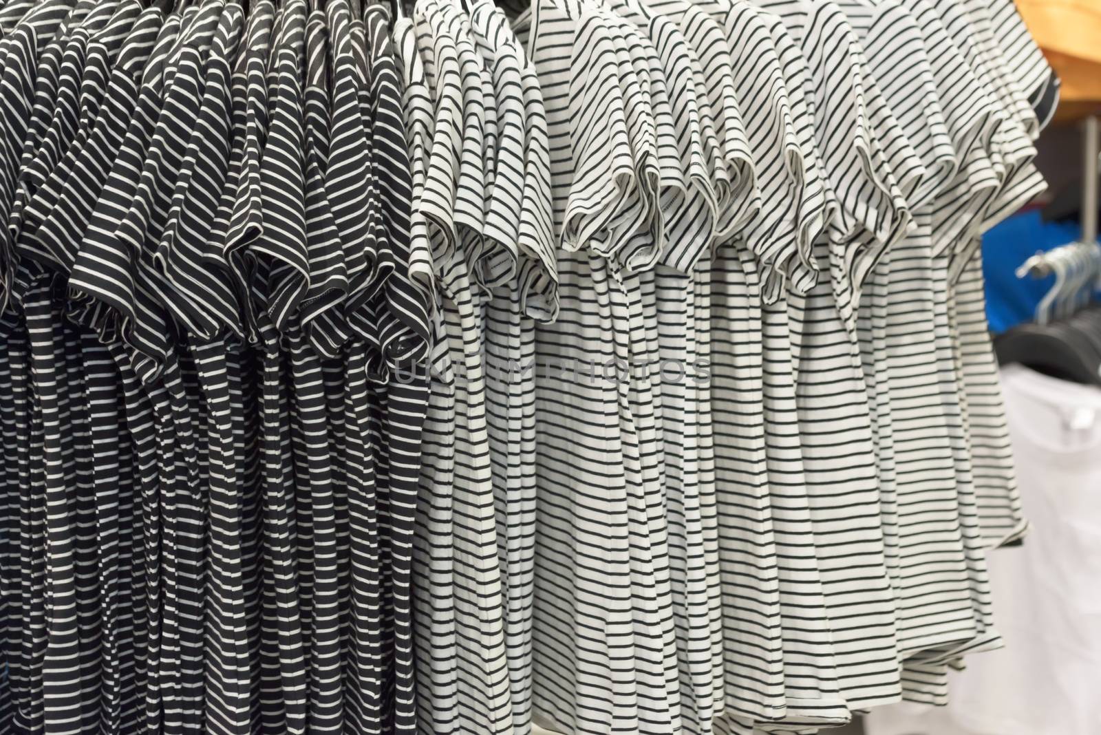 Rack with clothes in the store. Hangers with clothes in the store