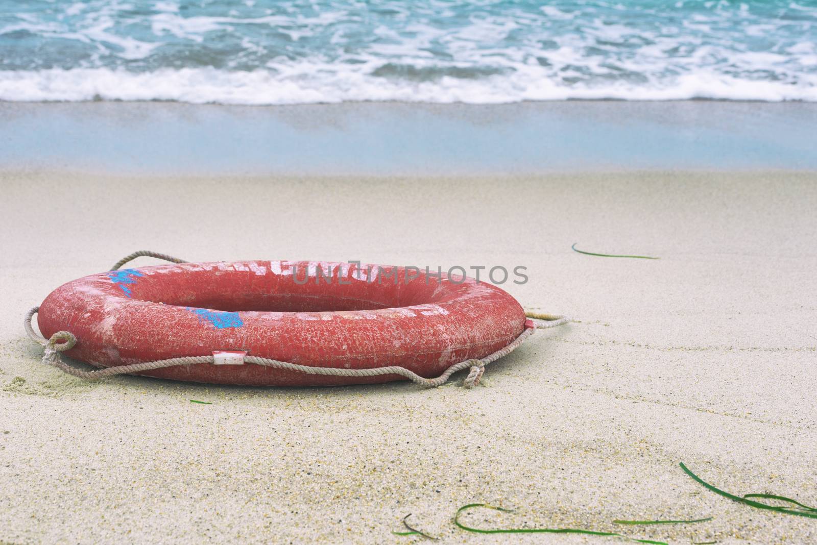 Lifebuoy on the beach. Concept of saving lives