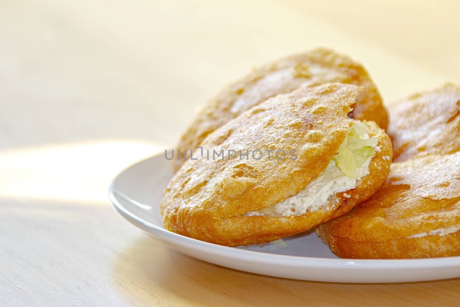 A close up of a Gordita "chubby" in Spanish is a Mexican cuisine is a pastry made with maize dough and stuffed with cheese, meat, or other fillings.