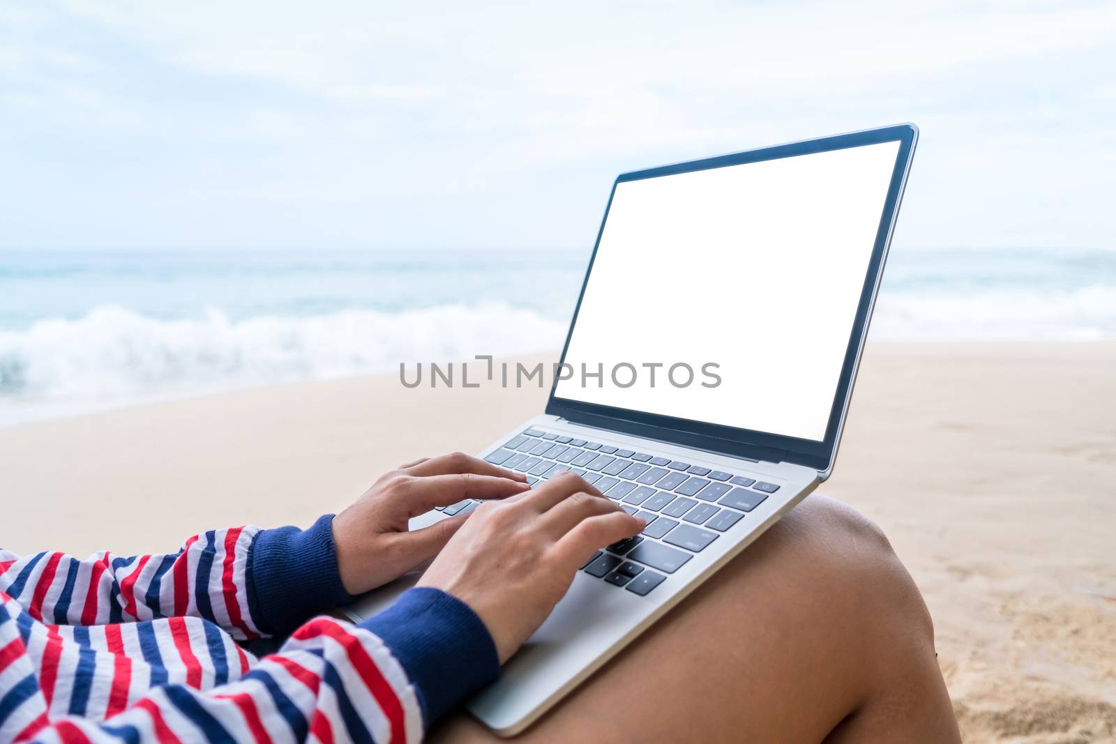 Woman using laptop and smartphone to work study in vacation day at beach background. by Suwant