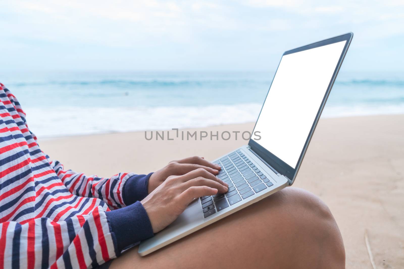 Woman using laptop and smartphone to work study in vacation day at beach background. Business, financial, trade stock maket and social network concept.