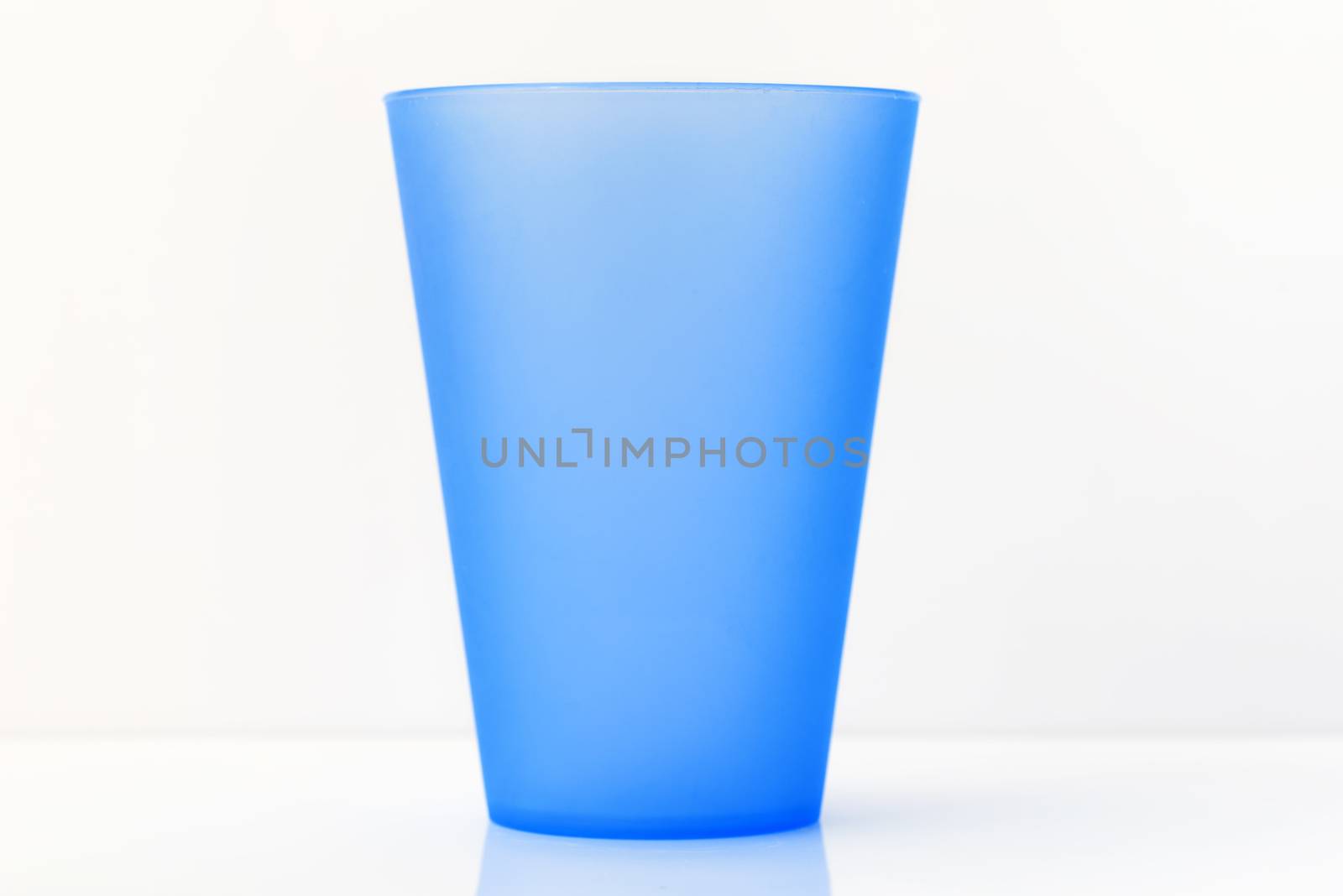 plastic cup on white background by Visual-Content