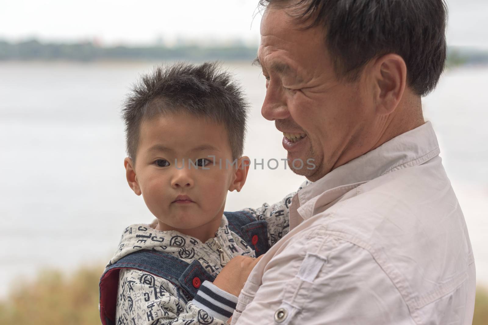 Harbin, Heilongjiang, China - September 2018: Portrait of Asian boy and grandfather. Grandfather with grandson