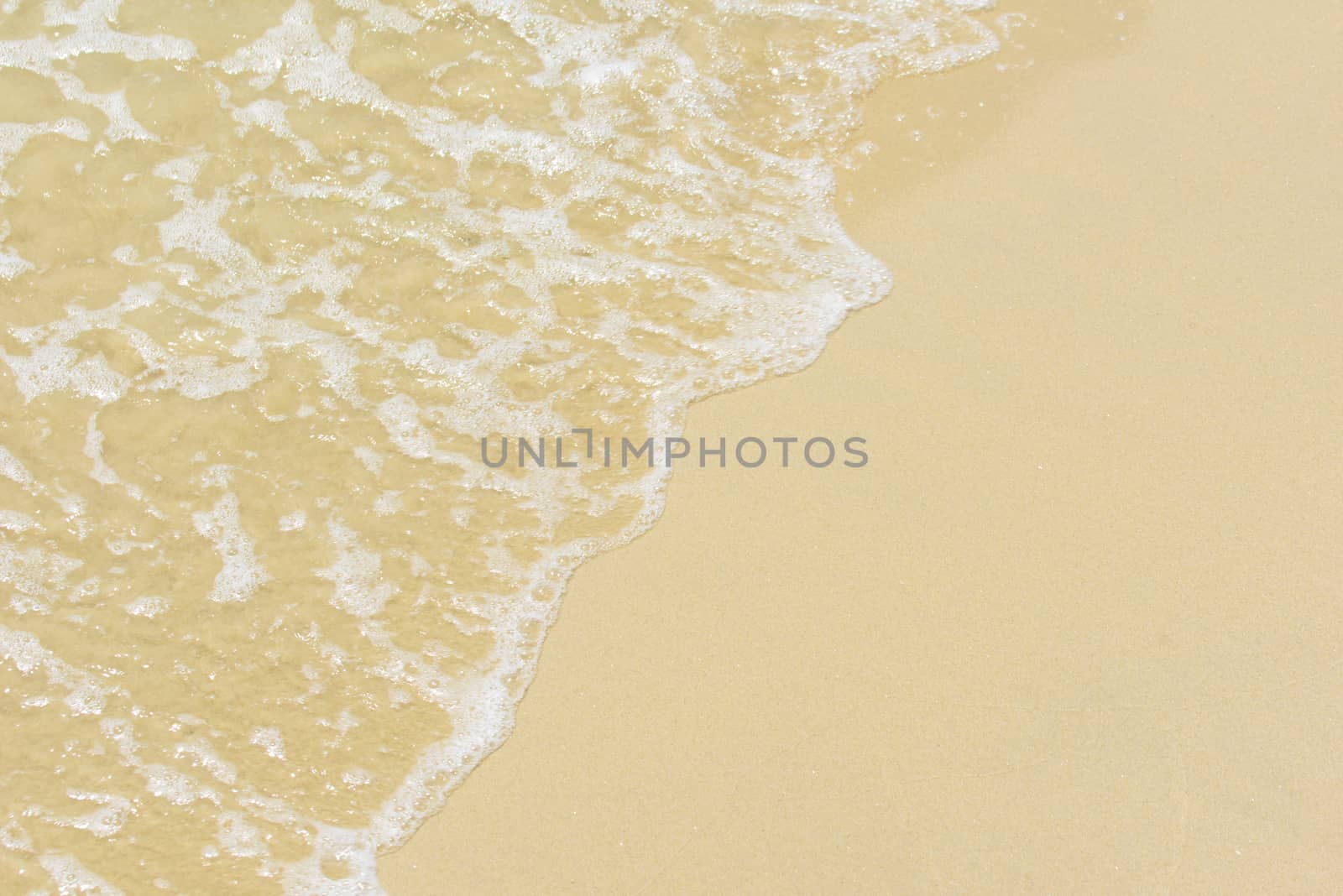 Sand under water. Glare on the sea surface