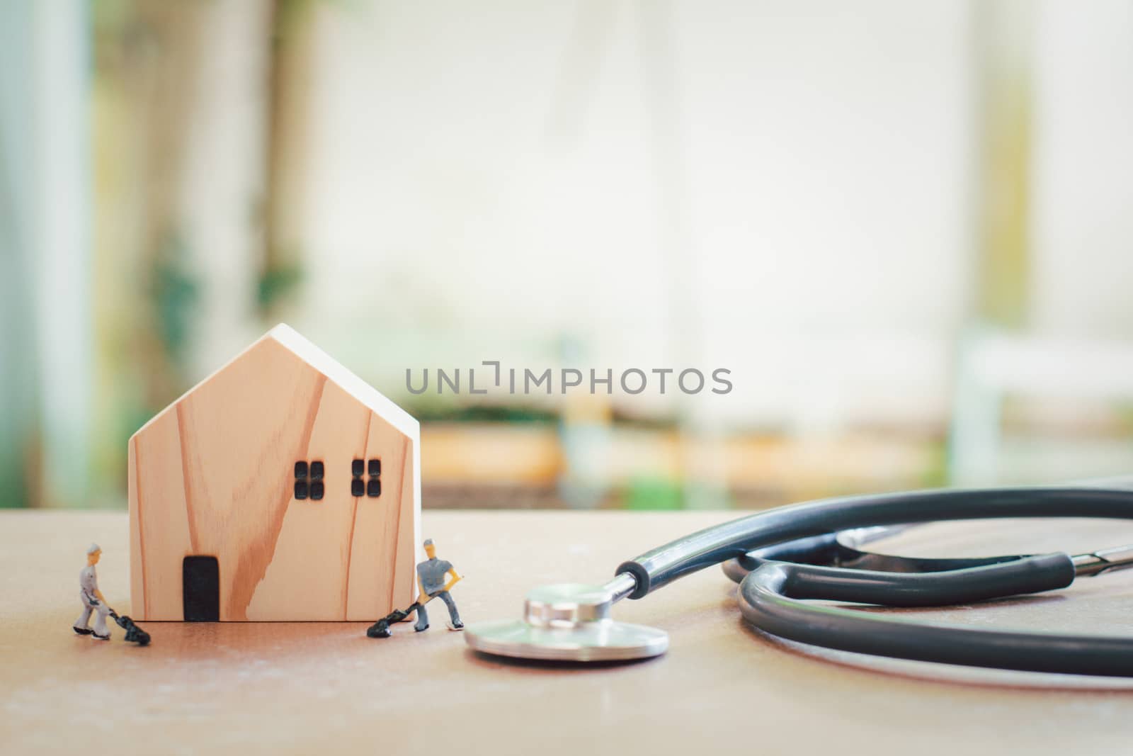 Home repair and inspector concept. Wooden home and stethoscope with blurry miniature or small technician fix and checking the house and real estate with copy 