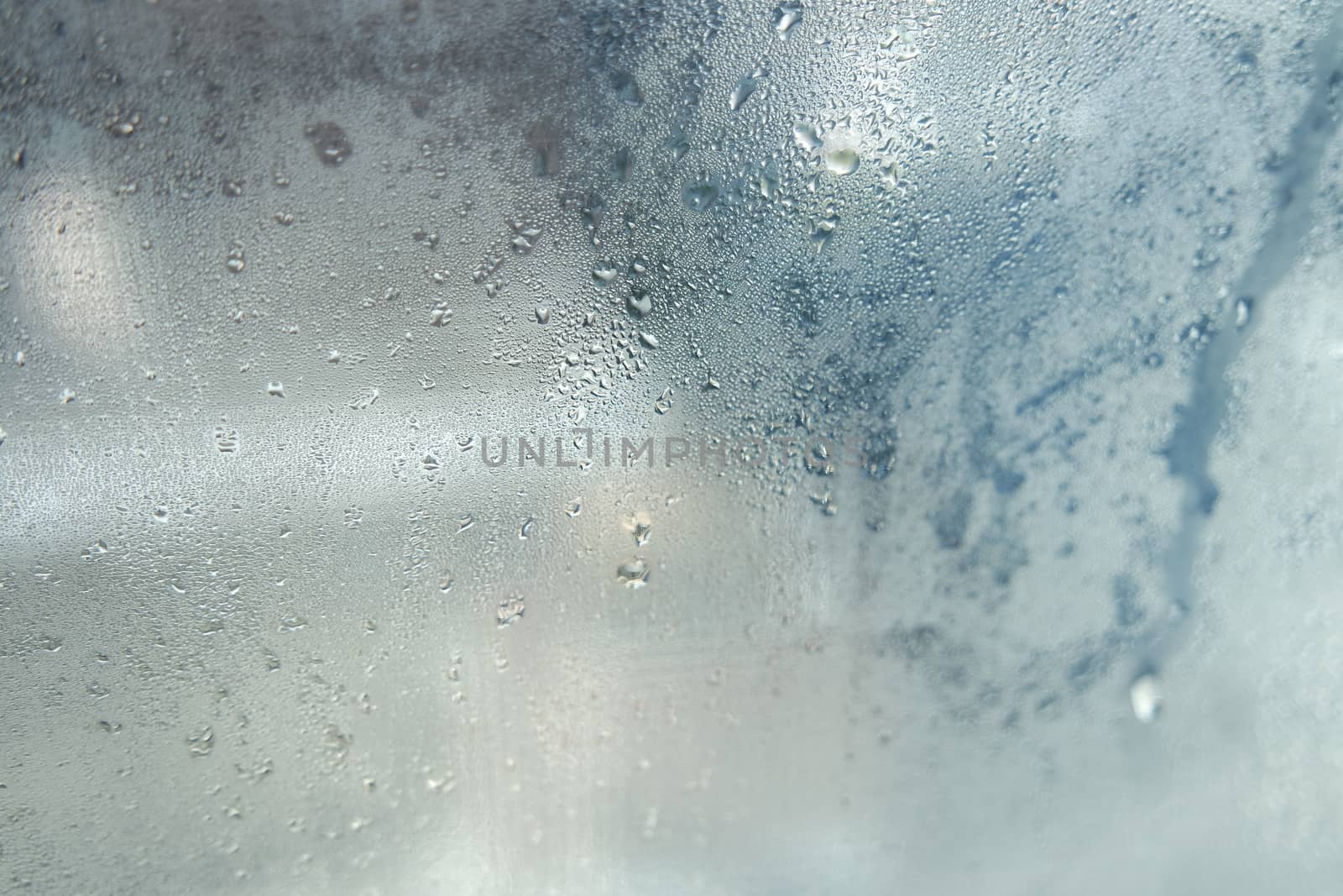 Bright grey color glassy texture, with water drops on it: abstract background